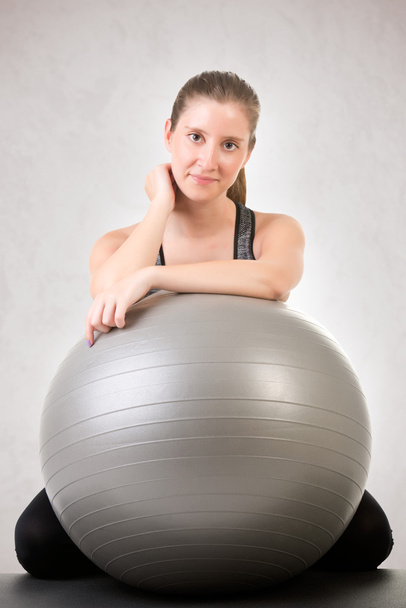 Mujer en forma sosteniendo una bola de pilates
 - Foto, imagen