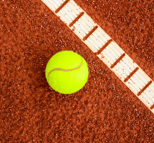 Tennis ball next to line on a tennis clay court - Foto, imagen