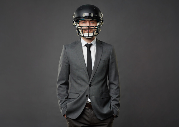 businessman in football helmet - Foto, imagen