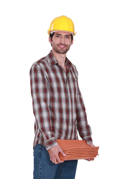 Tradesman carrying shingles - Фото, зображення