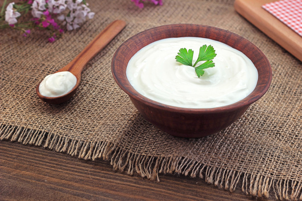 sour cream in a bowl on a wooden table - Photo, Image
