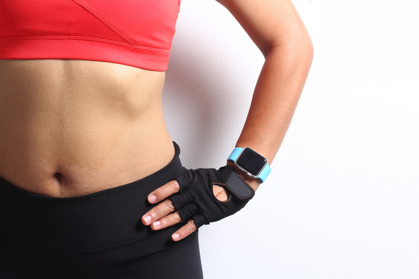 Sportswoman wearing smartwatch device. - Foto, Imagen