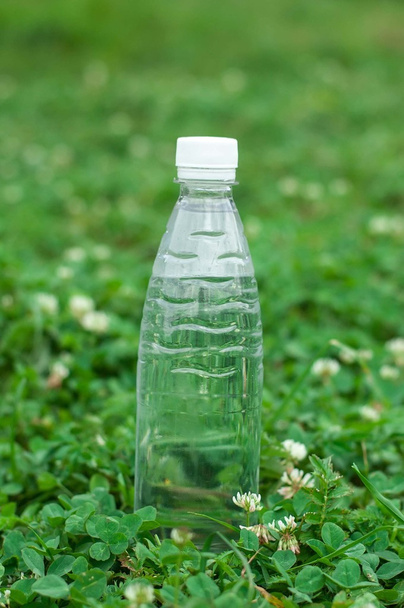 Láhev s vodou na pozadí trávy - Fotografie, Obrázek