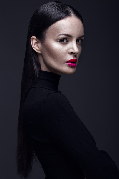 Beautiful brunette girl in a black dress, straight hair and trendy makeup. Glamour beauty face. - Фото, зображення