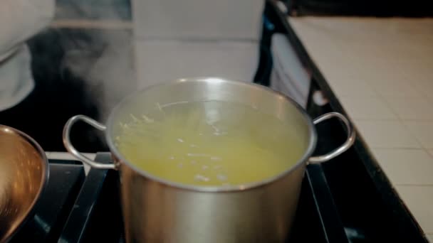Mid shot Pasta in pan on stove in the kitchen - Felvétel, videó