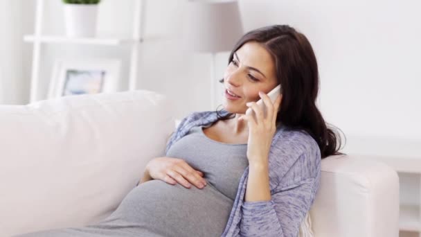 happy pregnant woman calling on smartphone at home - Imágenes, Vídeo