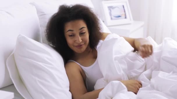 african woman sleeping in bed at home bedroom - Filmati, video