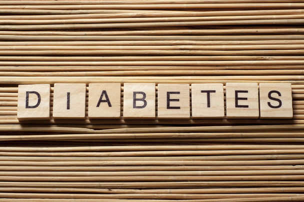 word diabetes on wooden cubes at wood background - Φωτογραφία, εικόνα