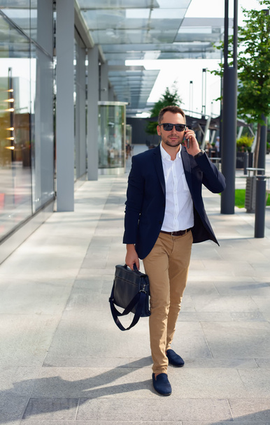 Businessman walking down the street with a briefcase - 写真・画像