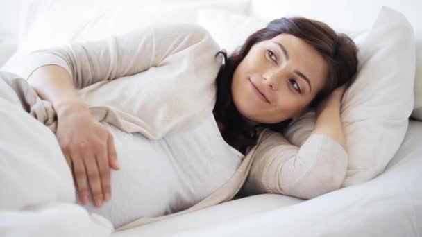 happy pregnant woman touching her tummy at home 59 - Materiał filmowy, wideo