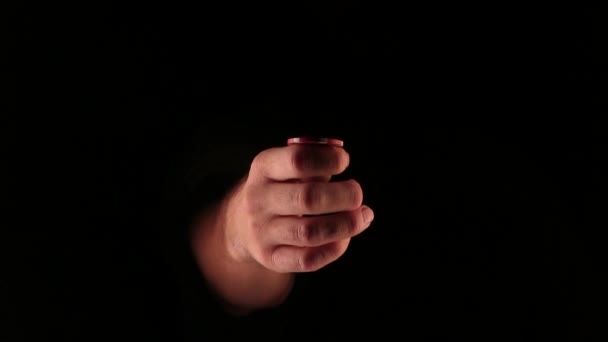 Mann im Dunkeln wirft hin und fängt Pokerchips ein - Filmmaterial, Video