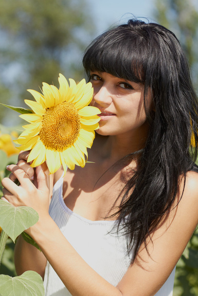 Young girl with sunflower outdoors - Foto, imagen