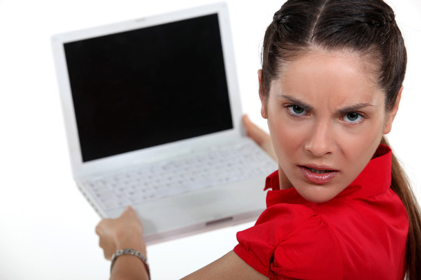 Annoyed woman with a blank computer screen - Foto, imagen