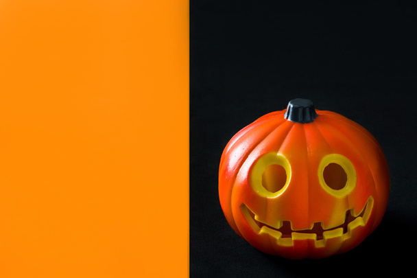 Halloween pumpkin on black and orange background - Фото, зображення