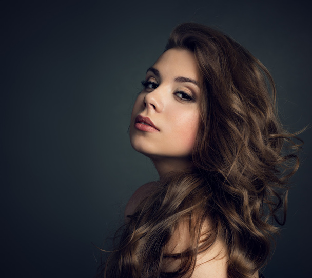 Portrait of a young beautiful brunette girl with long  hair - Photo, Image