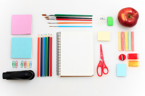 School set with notebooks, pencils, brush, scissors and apple on white background - Foto, Bild
