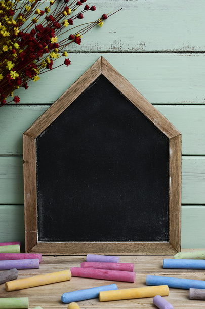 blank house-shaped chalkboard and chalk - Φωτογραφία, εικόνα