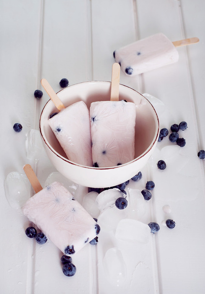Ice popsicles with yogurt and blueberries in ice lolly mold - Photo, image
