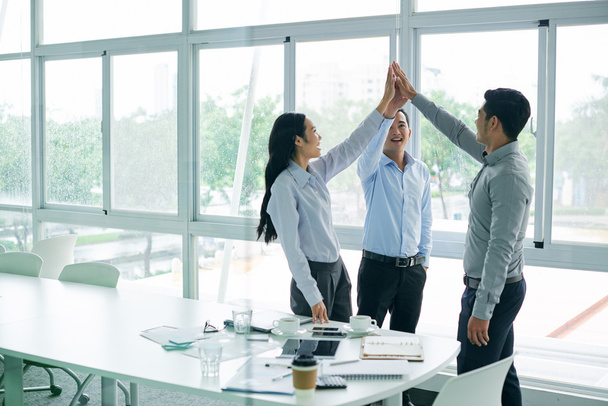 business executives giving high five - Photo, Image