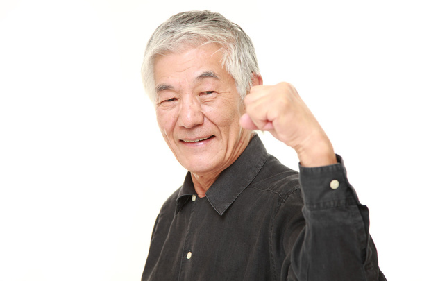 senior Japanese man in a victory pose  - Фото, изображение