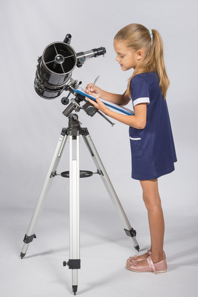 Young Astronomer writes the results of observations in the Documents folder - Photo, Image