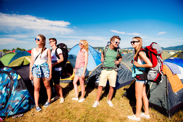 Teenagers in front of tents with backpacks, summer festival - Photo, image