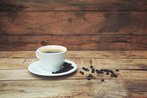 Чашка кави на дерев'яному столі
 - Фото, зображення