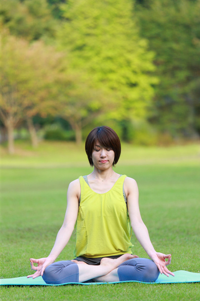 Japanese woman outside doing meditation - Photo, image