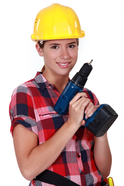 Pretty girl holding an electrical screwdriver - 写真・画像