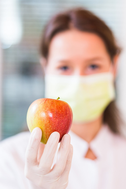 Doctor holding an apple - Foto, Imagen