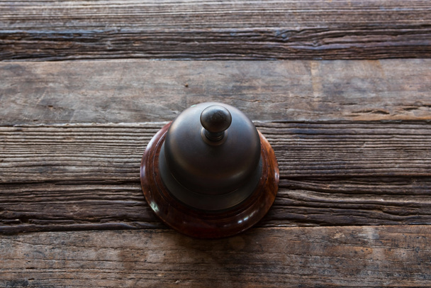 Классический колокол на деревянном столе
  - Фото, изображение