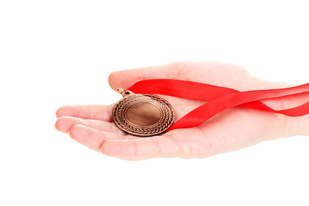 Bronze medal in hand isolated on white - Фото, зображення