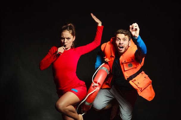 Lifeguards in life vest with ring buoy whistling. - Foto, Imagem