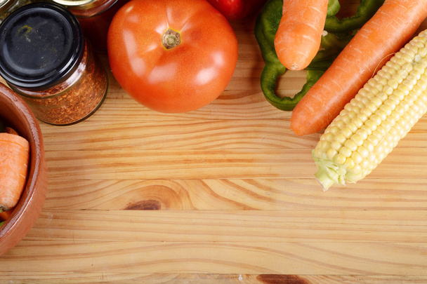 Vegetables and seasonings on wooden table. - Фото, изображение