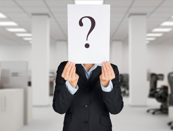 businessman holding paper with question marks - Photo, image