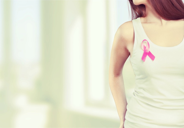  woman chest with pink badge  - Zdjęcie, obraz