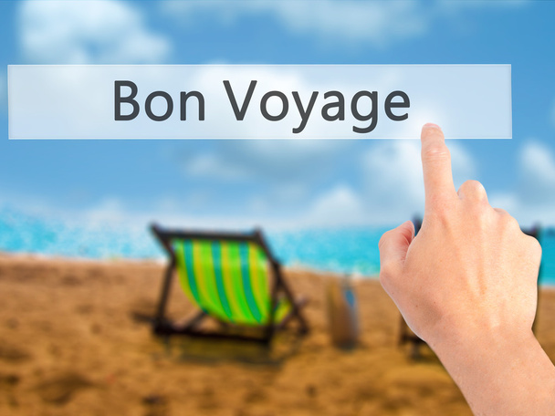Bon Voyage (heb een goede reis in het Frans)-hand drukken op een knop - Foto, afbeelding