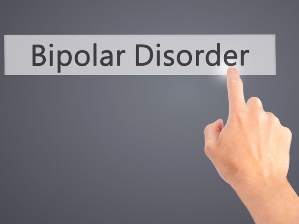 Bipolare Störung - Hand auf Knopfdruck auf verschwommenem Hintergrund  - Foto, Bild