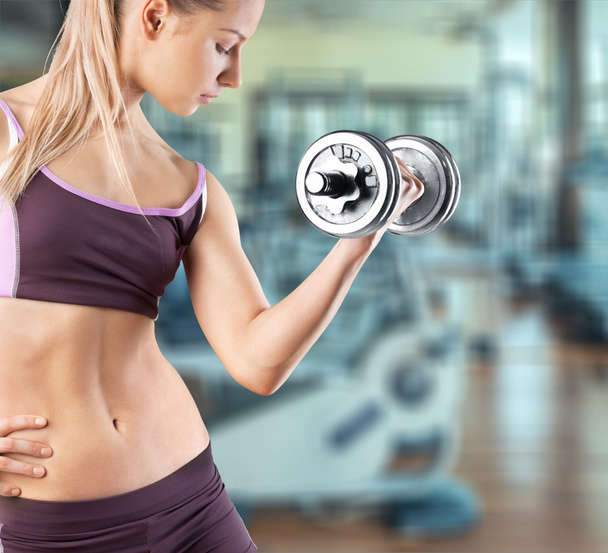 young woman holding dumbbell - Photo, image