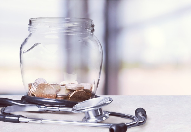 Money Jar with  coins  and stethoscope - Фото, зображення