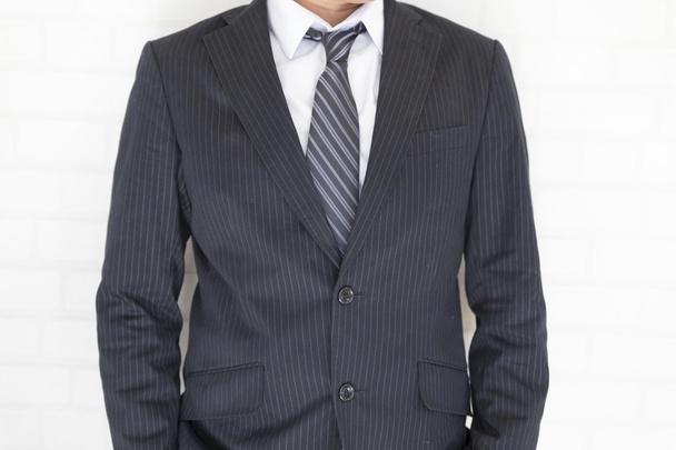 businessman in suit standing beside white wall - Photo, Image