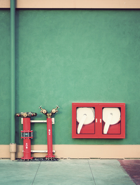 Oldtimer-Hydrant mit Wasserschläuchen und Feuerlöschgeräten - Foto, Bild