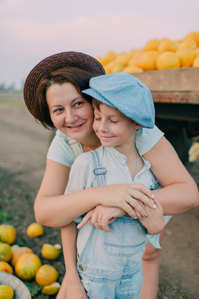 Mother and son in the cart with melons - Фото, зображення