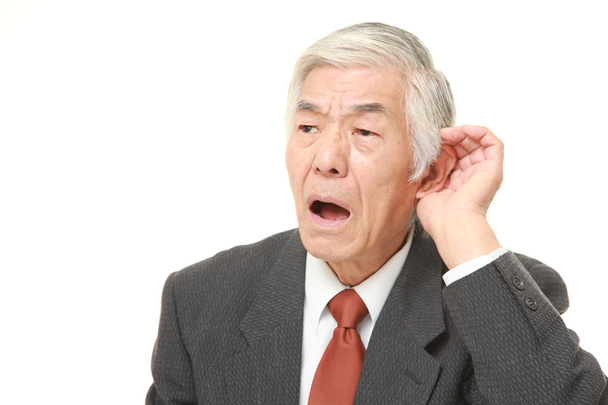 senior Japanese businessman with hand behind ear listening closely - Zdjęcie, obraz