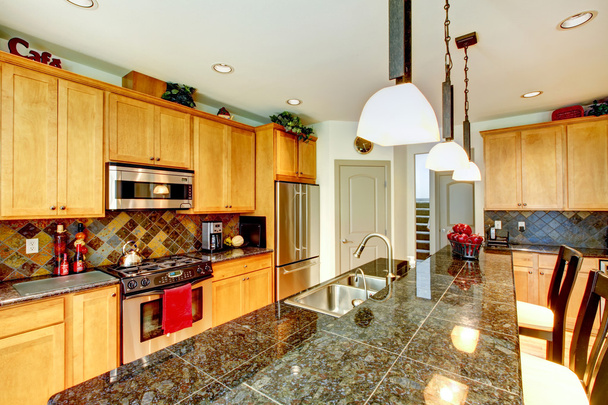 Kitchen room with brown cabinets, stainless steel, granite counter top. - Foto, Imagen