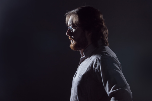 Man with beard, profile on dark background, the silhouette. - Valokuva, kuva