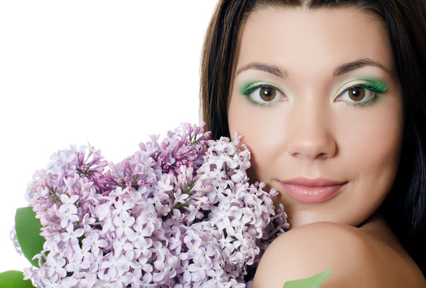 Beautiful woman with spring flowers of a lilac. Skincare - Valokuva, kuva