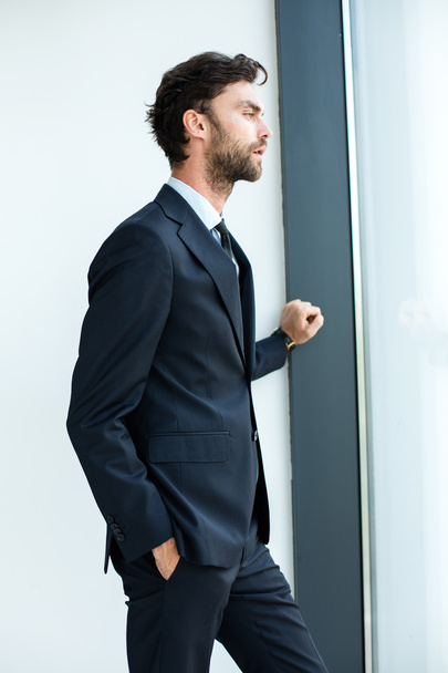 businessman standing next to a big window - Фото, изображение