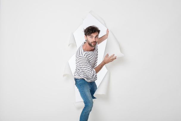 casual man breaking the paper background  - Foto, Bild