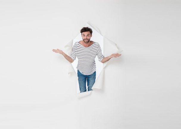 casual man breaking the paper background  - Foto, Imagen